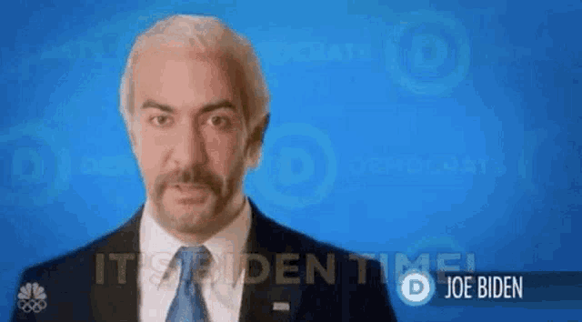 a man in a suit and tie is standing in front of a blue background that says joe biden