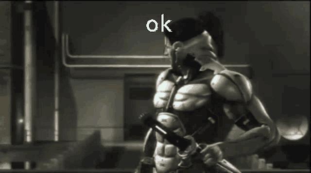 a man in a suit is holding a gun and the word ok is on the screen