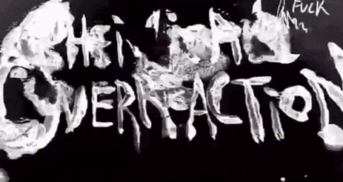a black and white image of the word overreaction written on a black surface .