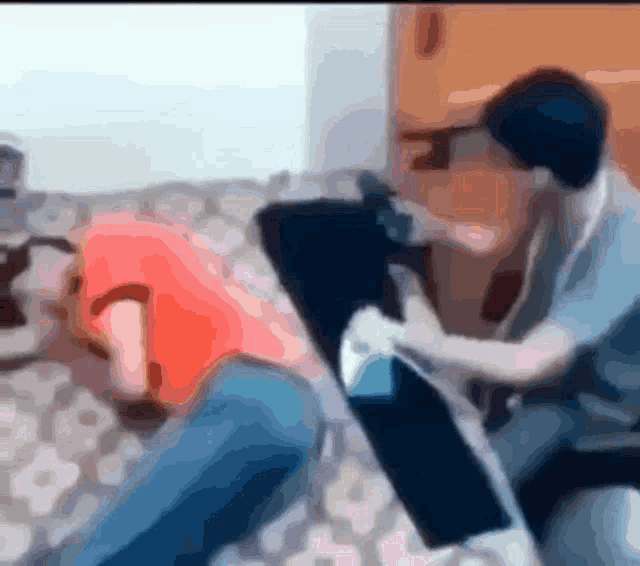 a blurry picture of a man sitting on a couch