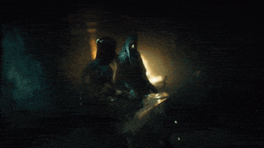 a blurred image of a person standing in a dark room