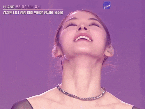 a close up of a woman 's face with a purple background that says i-land on it