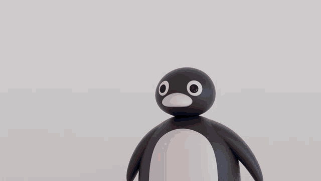 a close up of a penguin with big eyes and a red beak