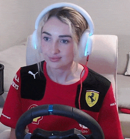 a woman wearing headphones and a red shirt with a ferrari logo on it