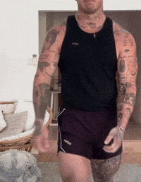 a man with a lot of tattoos on his arms and chest