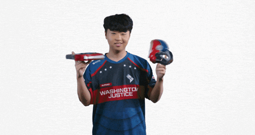 a man in a washington justice jersey holds a drill