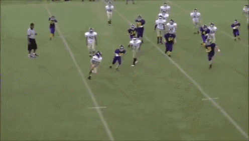 a football player with the number 56 on his jersey is being tackled by another player