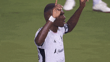 a soccer player wearing a white shirt that says guitel on it