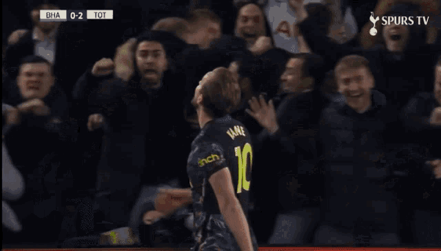 a soccer player with the number 10 on his jersey celebrates a goal