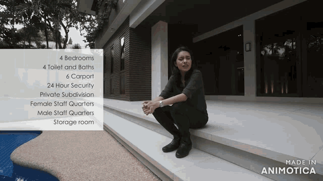 a woman is squatting on the steps of a house that has 4 bedrooms