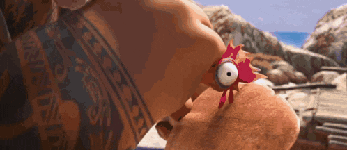 a close up of a person holding a stuffed chicken with big eyes .