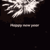 a picture of fireworks with the words `` happy new year '' written on it .