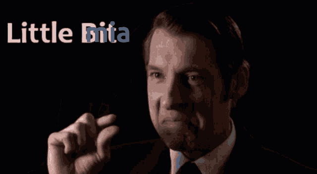 a man in a suit and tie is making a funny face with the words little bita above him