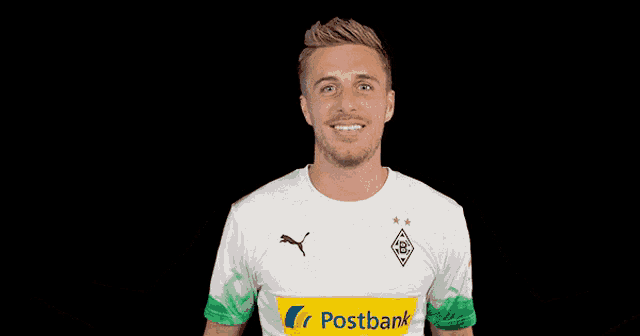 a man wearing a white shirt with the word postbank on the front