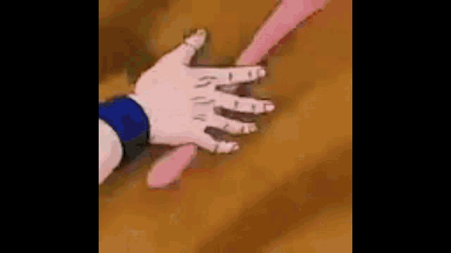 a close up of a person 's hand touching another person 's hand .
