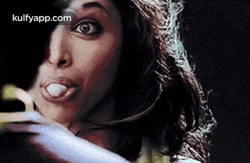 a close up of a woman 's face with her tongue out .