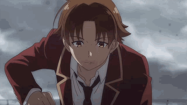 a man in a red suit and tie is looking at something