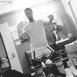 a black and white photo of a man taking a selfie in front of a mirror ..