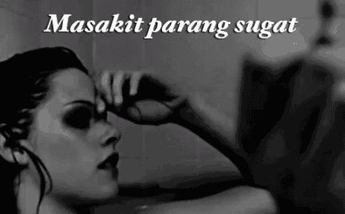 a black and white photo of a woman in a bathtub with the caption " masakit parang sugat "