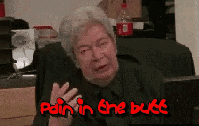 a man sitting in a chair with the words pain in the butt written in red