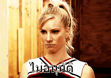 a cheerleader with a ponytail is wearing a red white and black uniform with a foreign language written on it