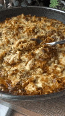 a close up of a pan of food with a spoon in it