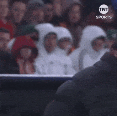 a man kicking a soccer ball on a field with tnt sports on the bottom