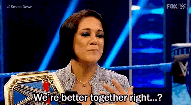 a woman is holding a wrestling championship belt and says `` we 're better together right ...? ''