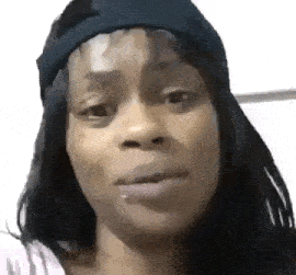 a close up of a woman 's face wearing a hat .