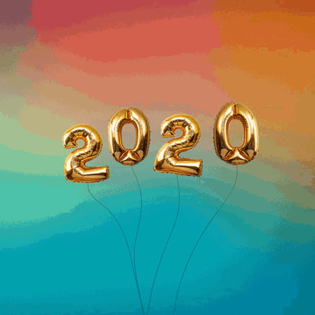 gold balloons in the shape of the numbers 2020 and 1 are floating in the air