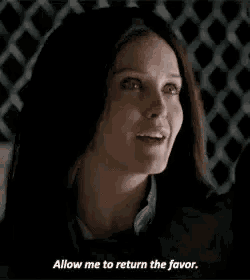 a woman is smiling and saying `` allow me to return the favor '' in front of a chain link fence .