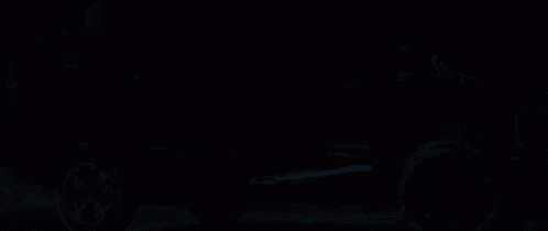 a close up of a fire in a dark room with a black background