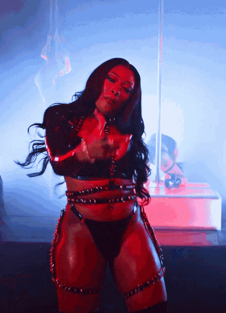 a woman in a black and red outfit is dancing