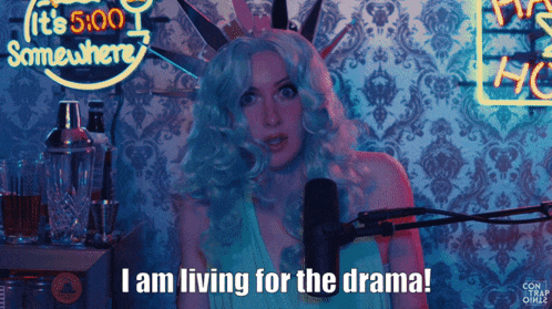a woman in a statue of liberty costume stands in front of a microphone and says i am living for the drama