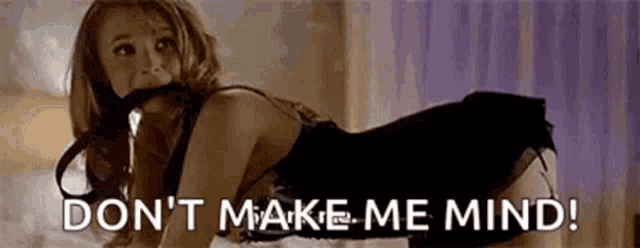 a woman in lingerie is laying on her stomach on a bed and says `` don 't make me mind ! ''