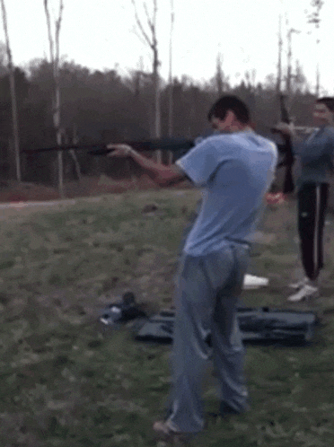 a blurry picture of a man in a blue shirt holding a bat