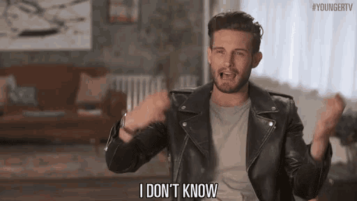 a man in a leather jacket is saying i don 't know in a living room .