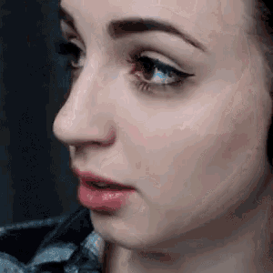 a close up of a woman 's face with eyeliner