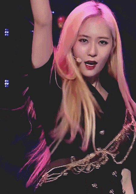 a woman with blonde hair is wearing a black top