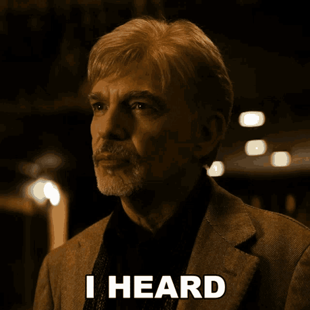 a man in a suit says i heard in front of his face