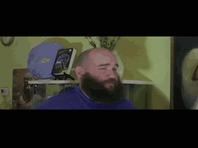 a bald man with a beard is giving a thumbs up and the words slow smolder are below him