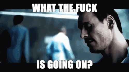 a man with a beard is looking down with the words what the fuck is going on below him