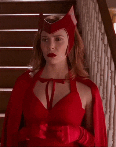 a woman in a red costume is standing on stairs .