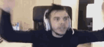 a man wearing headphones is sitting in a chair .