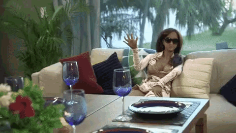 a woman is sitting on a couch in a living room