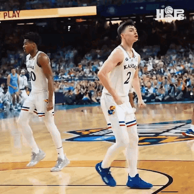 two basketball players from kansas are celebrating a win