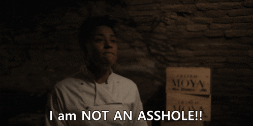 a man says i am not an asshole in front of two signs