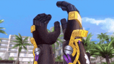 a pair of black and gold gloves with a purple ribbon around the wrist