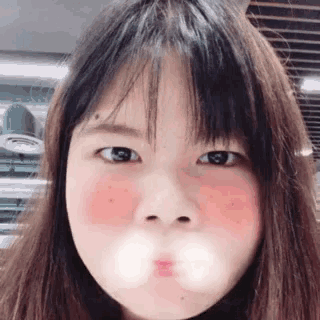 a close up of a young girl making a funny face