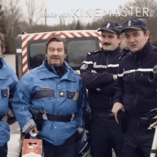 a group of police officers are standing next to each other .